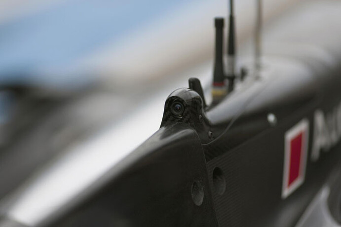 The camera lens is neatly integrated behind the car