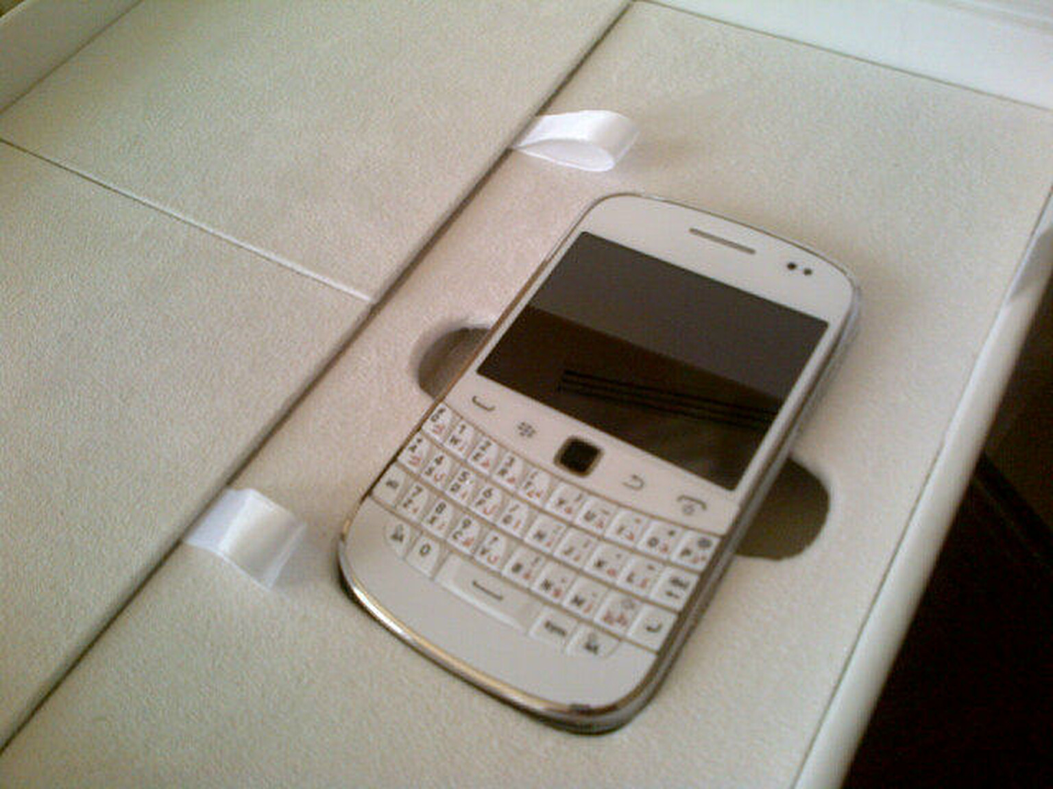 White BlackBerry Bold 9900 to go with your ivory three piece suit spotted in the wild