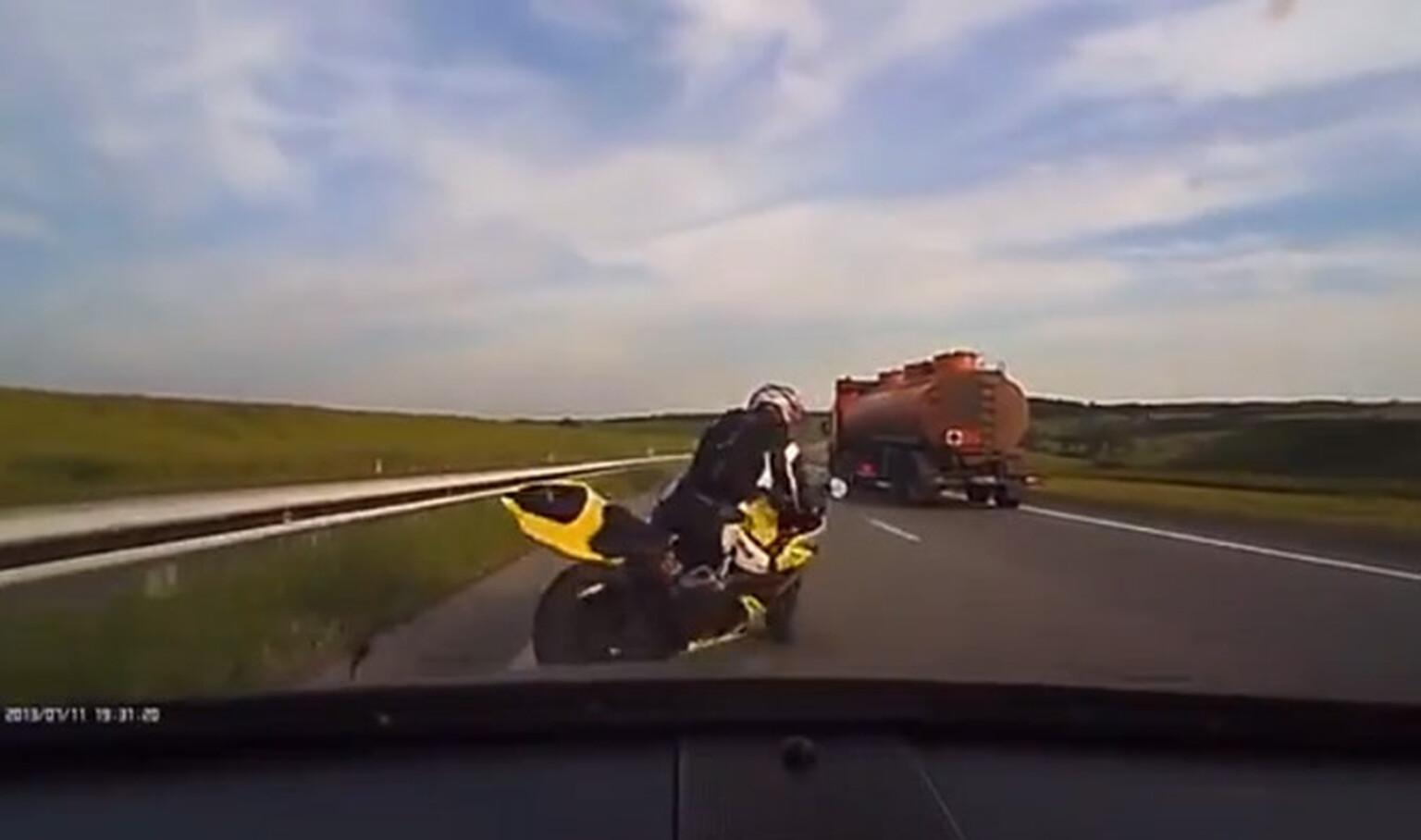 Motorcyclist brake checks car, pays the price