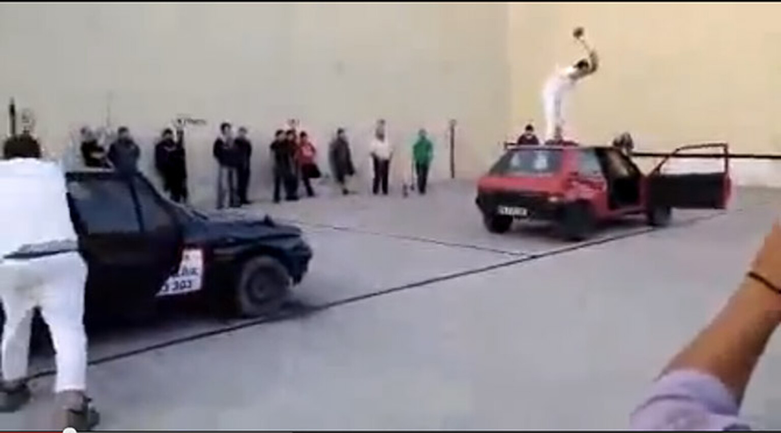 Two axe-wielding Spaniards go to town on a pair of Peugeot 205s
