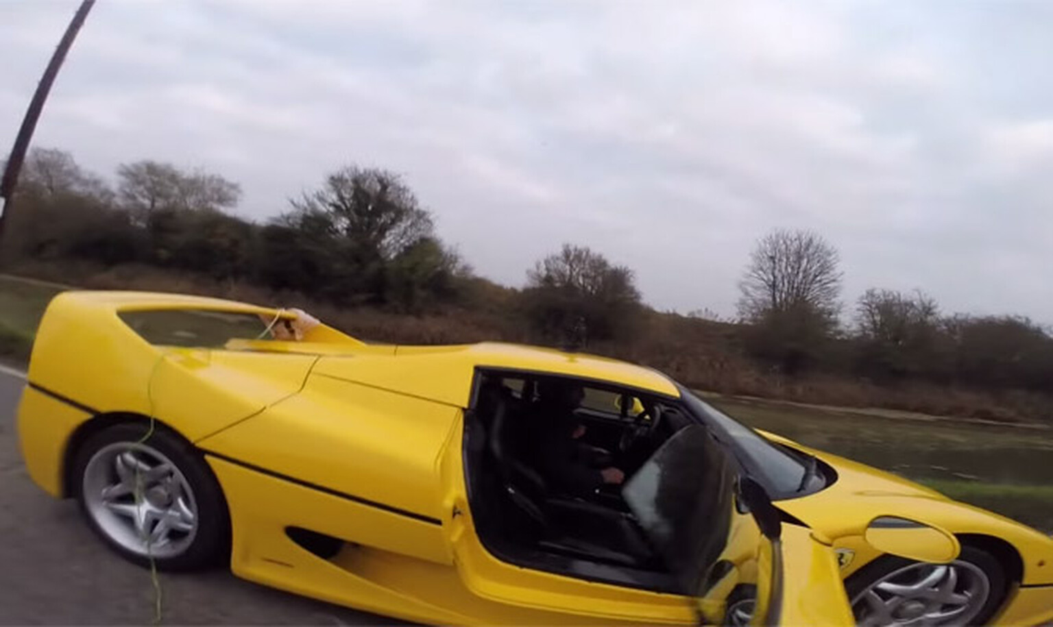 Want to see a man wakeboarding behind a Ferrari F50?