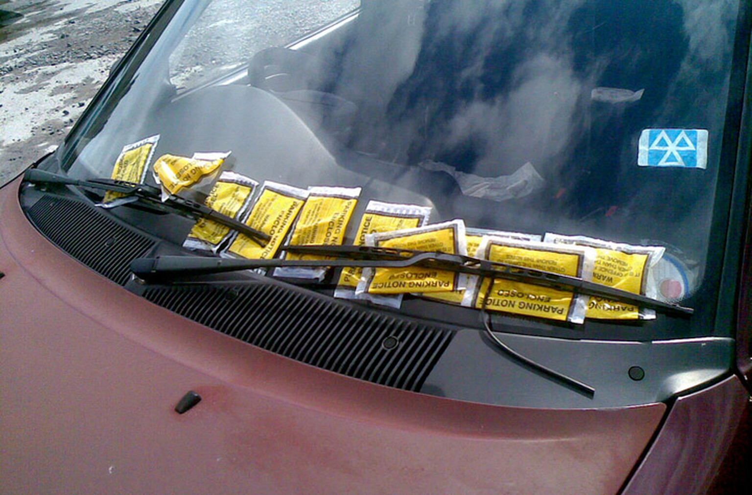 Traffic warden gives parking ticket to crashed taxi