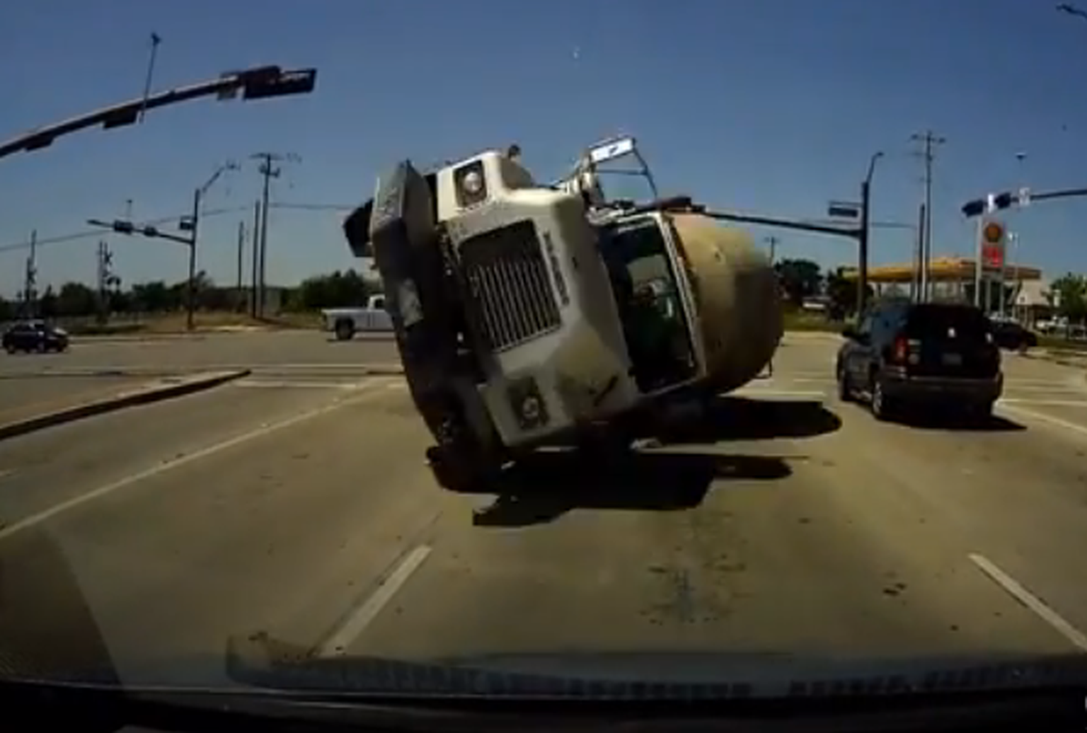 Watch this cement truck flip and slam into a car