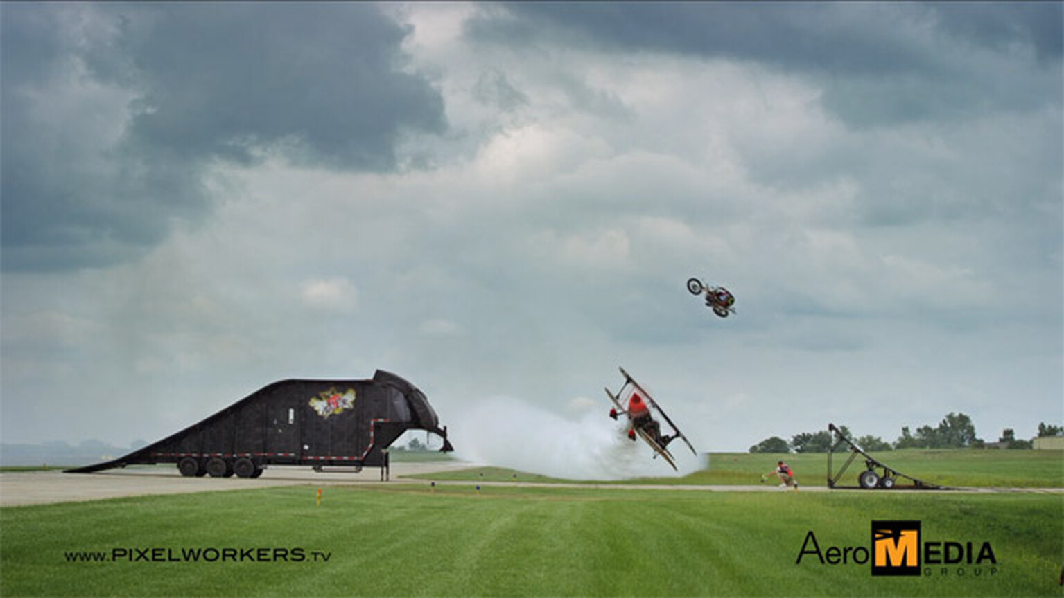 Motocross rider jumps over bi-plane in slow-motion