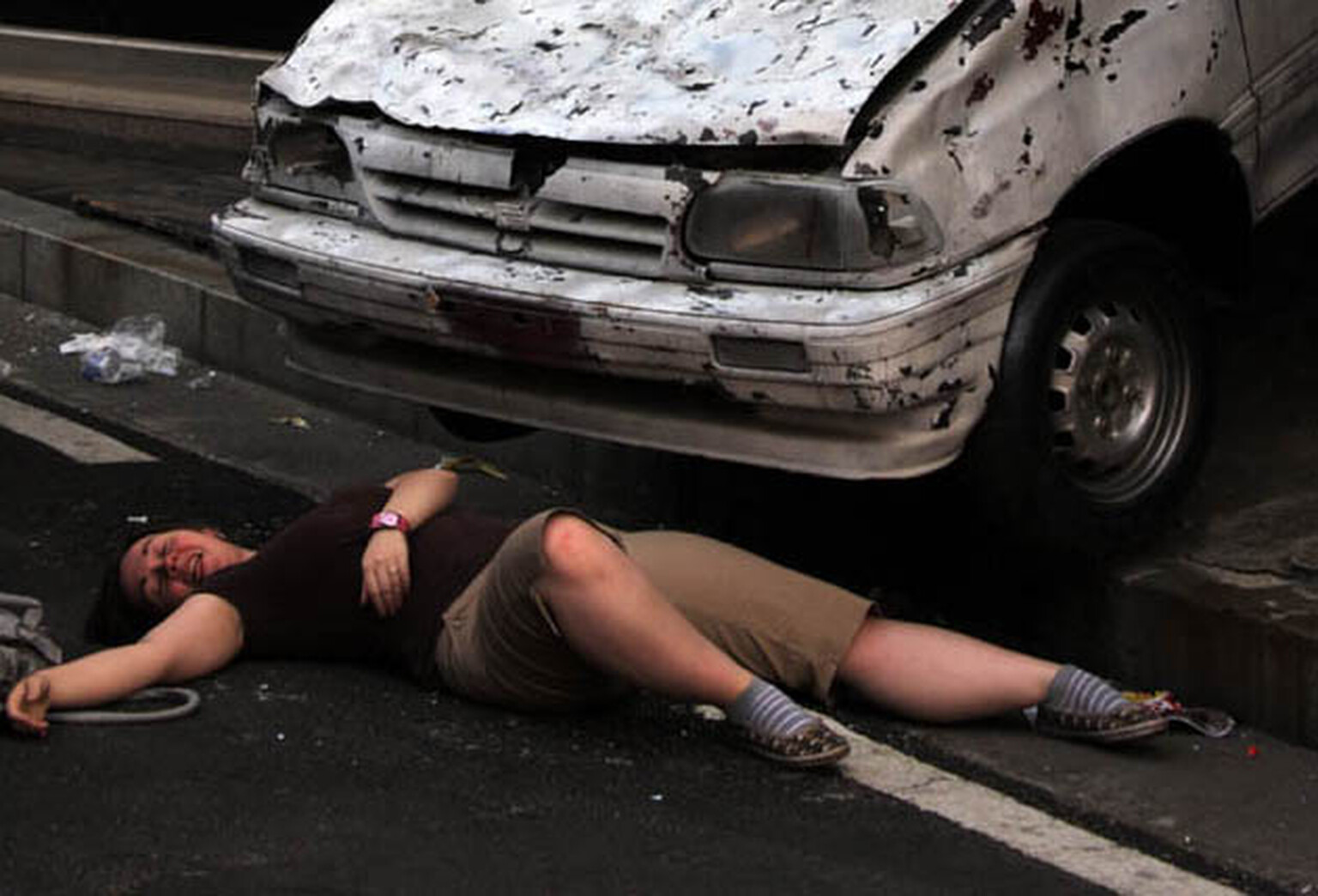 Woman run over three times by own car