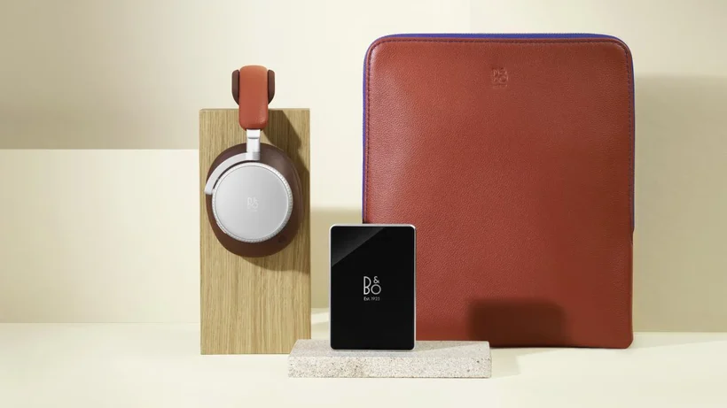 Beoplay H100 with read headphones and a red case