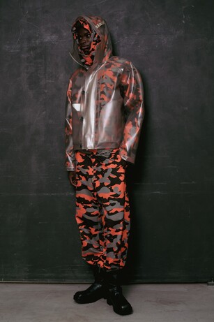 Ambush image showing a man wearing orange camo and a rain coat