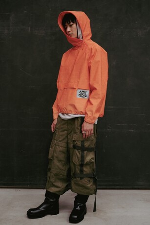 Ambushimage showing a man wearing an orange coat