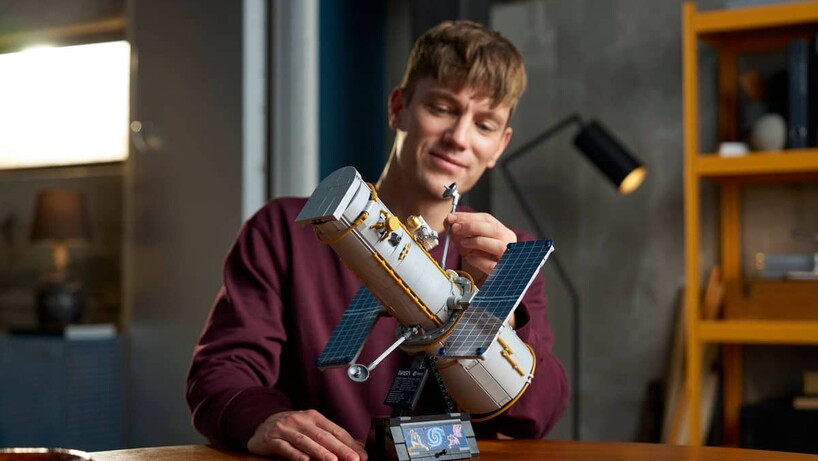 Man working on the Lego Hubble telescope