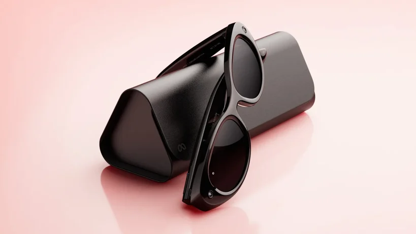 Meta Glasses and their case on a pink background