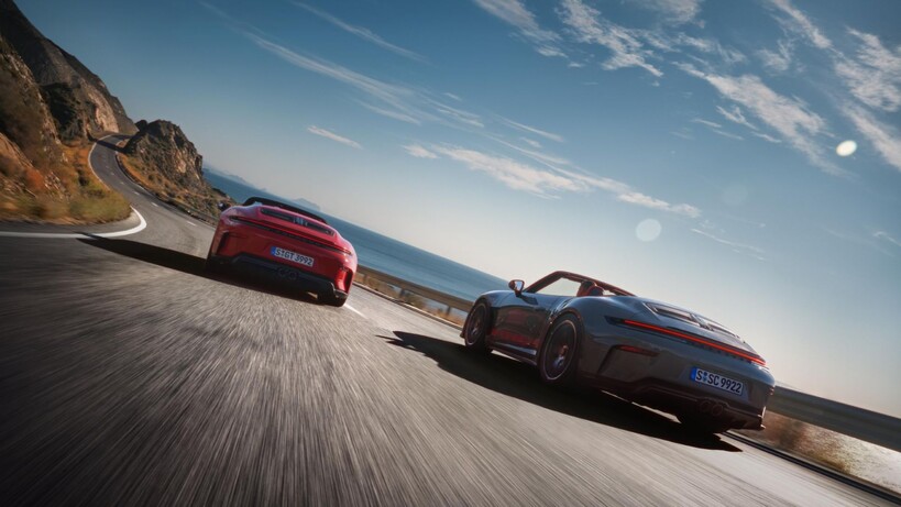 Two Porsche 911 cars driving