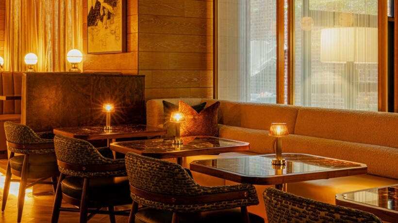 Redesigned Bourbon Lounge at Four Seasons Hotel Washington, DC with warm lighting and residential-inspired furnishings