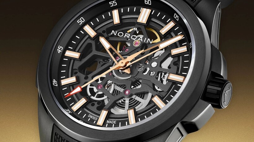 Norqain Independence Skeleton Titanium DLC watch with black openworked dial and red-gold accents