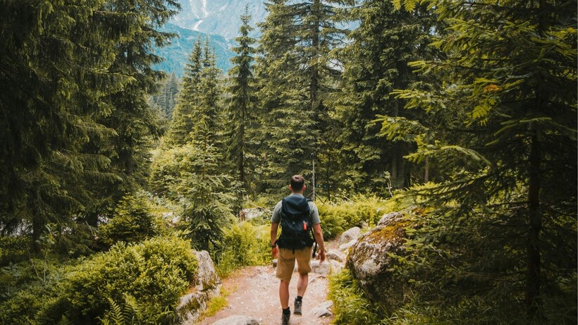 Person walking on an uneven outdoor trail to increase core stability and balance