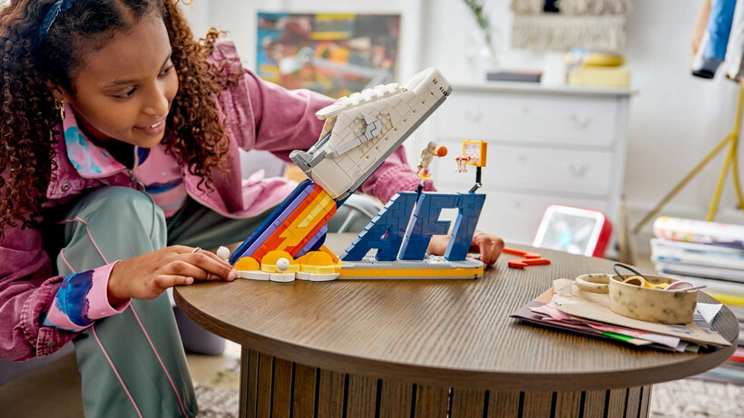LEGO Nike Air Force 1 set featuring a white and grey sneaker on a moon-themed display stand